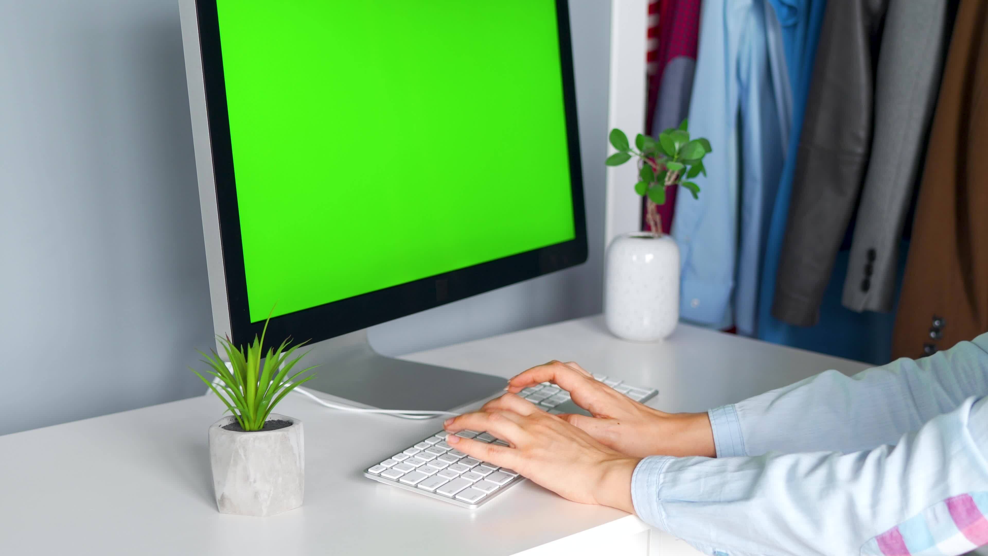 Woman Typing On A Computer Keyboard At Home Office Monitor With A woman-typing-on-a-computer-keyboard-at-home-office-monitor-with-a