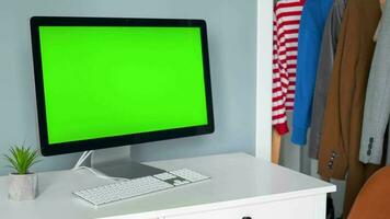 Woman typing on a computer keyboard at home office, monitor with a green screen. Chroma key. Copy Space. Concept of remote work. video