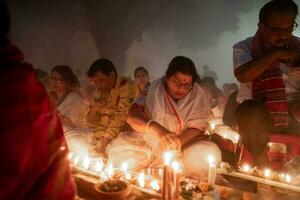 Narayanganj, Dhaka, Bangladesh, on November 12, 2022, Devotees offering prayers at the Shri Shri Lokanath Brahmachari Ashram temple during the Hindu religious fasting festival of Rakher Upobash. photo