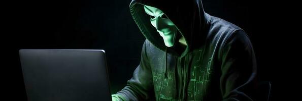 Unveiling the Enigmatic World of Cybercrime. A White Masked Hacker's Front View Amidst Dark Hood and Green Matrix Code Background photo