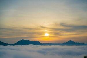 Beautiful sunrise with sea of fog in the early moring at phu thok chiang khan district leoi city thailand.Chiang Khan is an old town and a very popular destination for Thai tourists photo