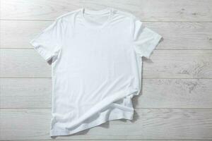 White shirt mockup isolated - pleated, wrinkled t-shirt on white background top view photo