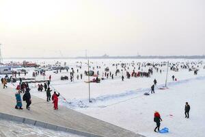 HARBIN, CHINA - JAN 18, 2017-People walking on the frozen Songhua River and There are many activities. January 18, 2017 in Harbin City, Heilongjiang, China. photo