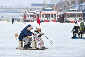 HARBIN, CHINA - JAN 18, 2017-People walking on the frozen Songhua River and There are many activities. January 18, 2017 in Harbin City, Heilongjiang, China. photo