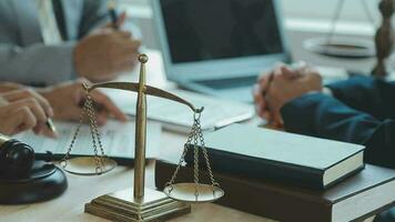 Justice and law concept.Male judge in a courtroom with the gavel, working with, computer and docking keyboard, eyeglasses, on table in morning light video