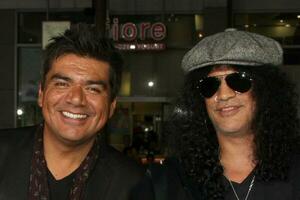 George Lopez Slash  Wives arriving at  the All About Steve Premiere at Graumans Chinese Theater  in  Los Angeles CA on August 26 20092009 photo