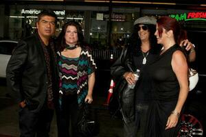 George Lopez Slash  Wives arriving at  the All About Steve Premiere at Graumans Chinese Theater  in  Los Angeles CA on August 26 20092009 photo