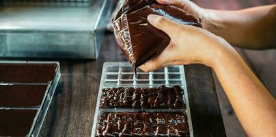 Close up of hand chef making homemade chocolate bars photo