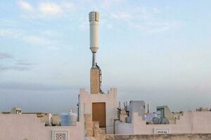 Mobile communication tower installed on the roof top photo