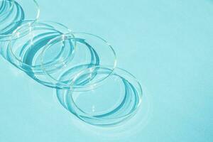 Petri dish. A set of Petri cups. A pipette, glass tube. On a blue blue background. photo