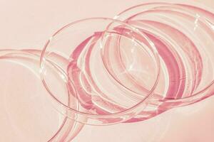 Petri dish. A set of Petri cups. A pipette, glass tube. On a pink background. photo