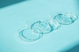 Petri dish. A set of Petri cups. A pipette, glass tube. On a blue blue background. photo