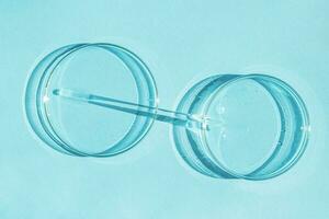Petri dish. A set of Petri cups. A pipette, glass tube. On a blue blue background. photo