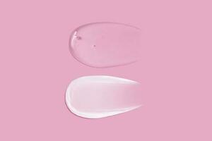 Cream smear texture and transparent gel smear texture on pink background photo