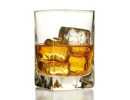 Whiskey with ice in glass on a white background photo