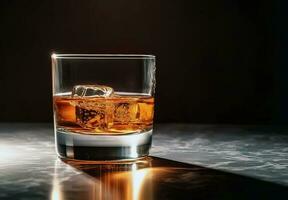 Whiskey with ice in glass on black background photo