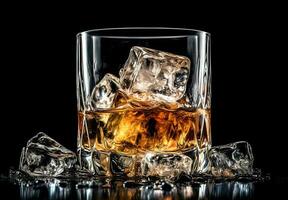 Whiskey with ice in glass on black background photo