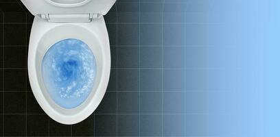 Top view of toilet bowl, blue detergent flushing in it photo