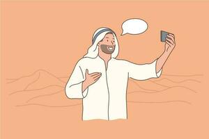 Travelling, tourism, smartphone, arabia concept. Young happy smiling cheerful man guy muslim arab witn kandura making selfie on mobile phone in desert. Communication through device and showing views. vector