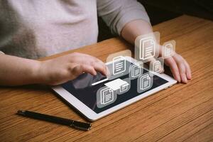 Woman working on laptop to Document Management System DMS. Software for archiving, searching and managing corporate files and information. Virtual screen. photo