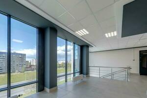 empty modern hall room with columns, doors and panoramic windows. photo