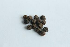 Black pepper on a white background. photo