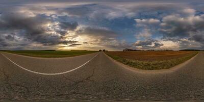 360 hdri panorama on asphalt road with evening clouds on evening sky in golden hour before sunset in equirectangular spherical projection, as sky replacement in drone panoramas, game development photo