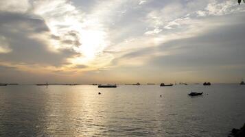 Stunning sunset seascape at the horizon in afternoon, view from the port or harbor. photo