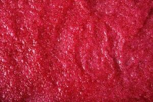 Texture of organic berry scrub with sugar and seeds. Close-up photo