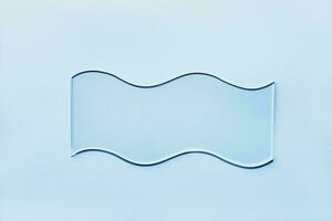 Empty glass wavy slide on blue background. Mockup for cosmetic or scientific product sample photo