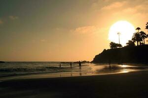 Big sun at sunset on the California coast photo