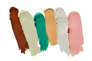 Samples of color correcting concealers Set isolated on white background. Swatch smears of cream makeup base photo