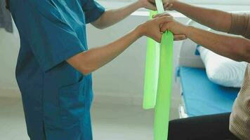 young asian physical therapist working with senior woman on walking with a walker video