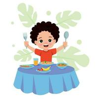 A boy is eating a meal with a fork and spoon. vector