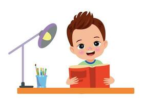 A boy is reading a book on a desk. vector