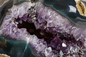 Macro Mineral Stone Amethysts in the rock on a white background photo