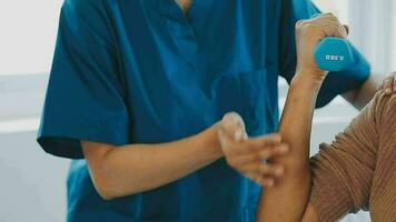 young asian physical therapist working with senior woman on walking with a walker video