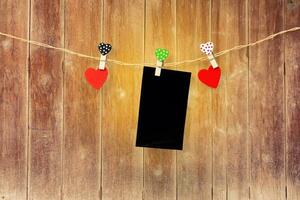 Handmade two wood hearts hanging and card on cloth line or photo
