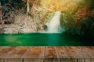 wood walk way with waterfall in rain forest background. photo