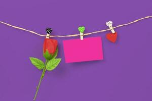 Handmade wood hearts hanging on cloth line and rose flower photo