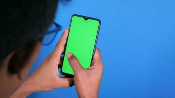 Young man using smart phone browsing internet video