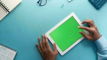 Top view of businessman using digital tablet on blue background video