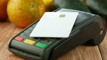 Credit card, pos machine and fruits on table video