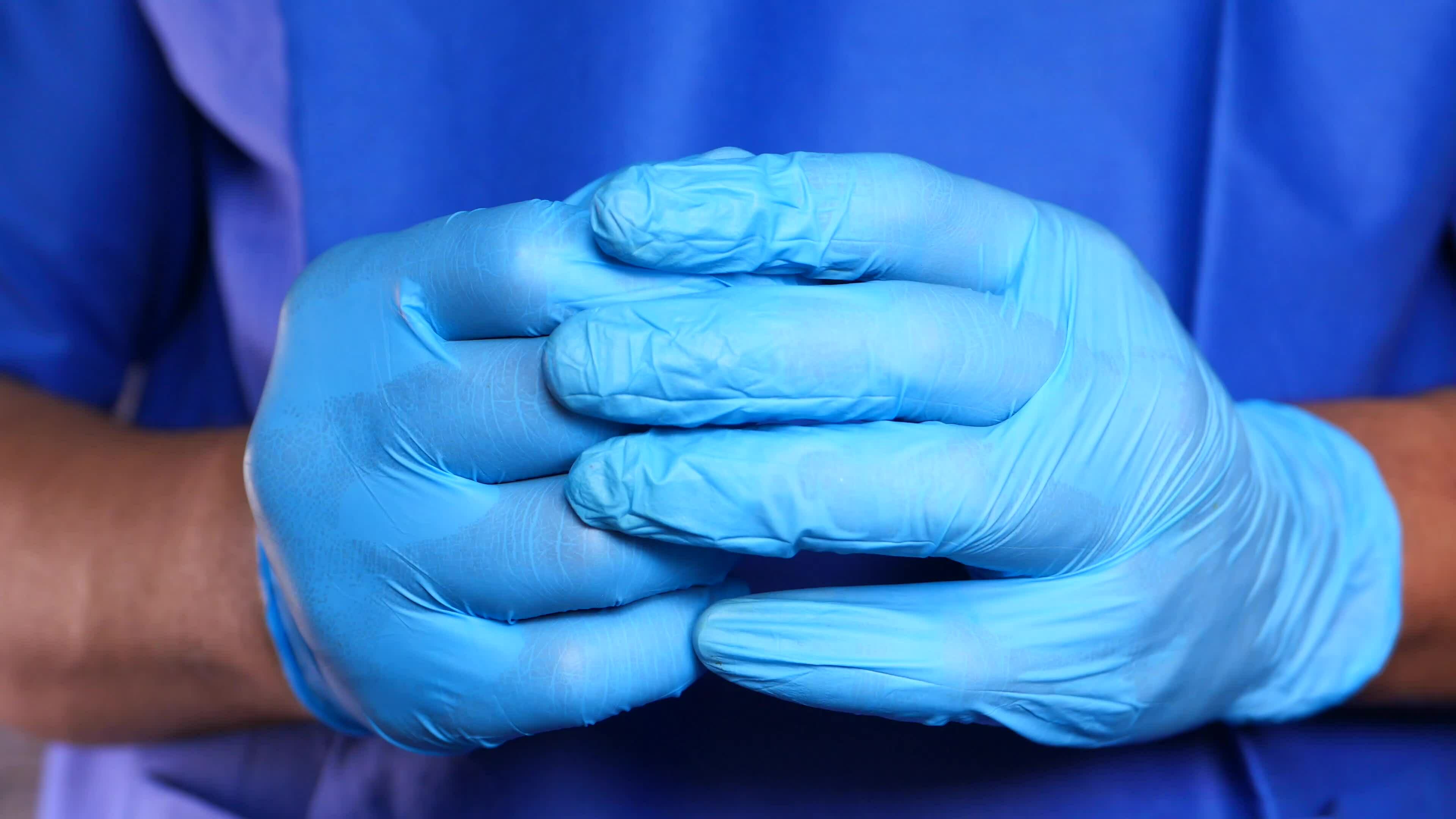 doctor hand in medical latex gloves against blue background 23527883