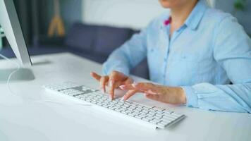 Woman typing on a computer keyboard at home office, monitor with a green screen. Chroma key. Copy Space. Concept of remote work. video