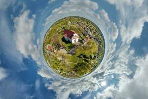 little planet transformation of spherical panorama 360 degrees overlooking church in center of globe in blue sky. Spherical abstract aerial view with curvature of space. photo