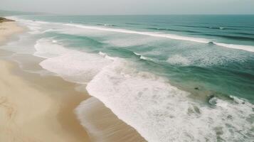 Airborne see of sandy shoreline with waves and clear sea water. photo