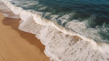 Airborne see of sandy shoreline with waves and clear ocean water. photo