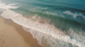 Airborne see of sandy shoreline with waves and clear ocean water. photo