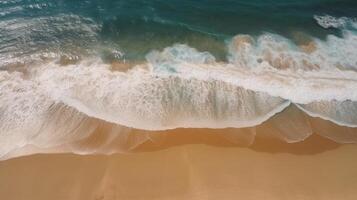 Airborne see of sandy shoreline with waves and clear ocean water. photo